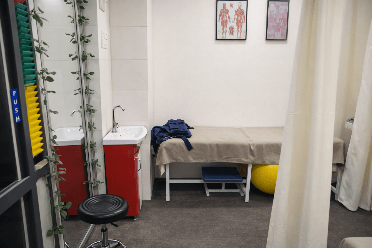 Treatment room at City Physiotherapy with a treatment bed and privacy curtain